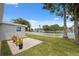 This home has a patio and a grassy yard that meet the water at 2252 Society Dr, Holiday, FL 34691