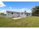 The backyard offers a bench on a patio, and a large grassy space at 2252 Society Dr, Holiday, FL 34691