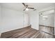 This bedroom offers wood-look flooring, a ceiling fan, and a mirrored closet at 2252 Society Dr, Holiday, FL 34691