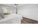 Large bedroom has luxury vinyl floors, ceiling fan, and mirrored closet at 2252 Society Dr, Holiday, FL 34691
