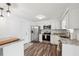 Bright kitchen features stainless steel appliances, white cabinets, and stone countertops at 2252 Society Dr, Holiday, FL 34691