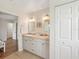 Bright bathroom featuring a double vanity with two sinks, updated hardware, and a neutral color palette at 2626 Cheryle Ln, Sarasota, FL 34237