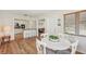 Bright dining room adjacent to the kitchen with a white table, wainscotting, and natural light at 2626 Cheryle Ln, Sarasota, FL 34237