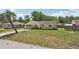Charming single-story home with a well-maintained lawn, mature trees, and a welcoming front porch at 2626 Cheryle Ln, Sarasota, FL 34237