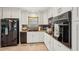 Traditional kitchen design with white cabinets, granite counters, and black appliances at 2626 Cheryle Ln, Sarasota, FL 34237