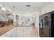 Open concept kitchen with granite countertops and views to the living and dining areas at 2626 Cheryle Ln, Sarasota, FL 34237