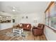 Inviting living room featuring hardwood floors, comfortable seating, and an adjacent open kitchen at 2626 Cheryle Ln, Sarasota, FL 34237