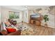Cozy living room with a map mural, hardwood floors, and comfortable leather seating at 2626 Cheryle Ln, Sarasota, FL 34237