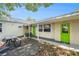 Backyard with wooden deck, perfect for dining and entertaining outdoors with two green doors at 2627 8Th N Ave, St Petersburg, FL 33713