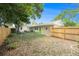 A cozy backyard with trees, grass, grill, and privacy fence at 2627 8Th N Ave, St Petersburg, FL 33713