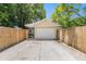 Two car garage with a large driveway and light exterior at 2627 8Th N Ave, St Petersburg, FL 33713