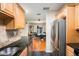 Modern kitchen with stainless steel appliances, black countertops, and views into the eat-in area at 2627 8Th N Ave, St Petersburg, FL 33713