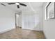 Bright bedroom with modern ceiling fan, neutral walls, and spacious closet at 2725 Countryside Blvd # 103, Clearwater, FL 33761