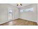 Bright bedroom with wood floors, ceiling fan, and door to the exterior at 281 44Th Ave, St Pete Beach, FL 33706
