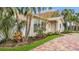 This home's exterior is surrounded by lush landscaping and a brick driveway at 281 44Th Ave, St Pete Beach, FL 33706