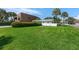 Well-maintained front yard with lush green grass and tropical landscaping at 281 44Th Ave, St Pete Beach, FL 33706