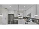 Modern kitchen features white cabinets, stainless steel appliances, and stylish backsplash at 281 44Th Ave, St Pete Beach, FL 33706