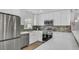 Updated kitchen featuring white cabinets, stainless steel appliances, and stylish backsplash at 281 44Th Ave, St Pete Beach, FL 33706