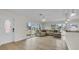 Bright living room featuring hardwood floors, modern lighting fixtures, and a welcoming aesthetic at 281 44Th Ave, St Pete Beach, FL 33706