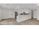 Open concept living space with modern kitchen, stainless steel appliances, and bright living room at 281 44Th Ave, St Pete Beach, FL 33706