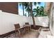 Private patio with brick pavers, providing an intimate outdoor seating area surrounded by palm trees at 281 44Th Ave, St Pete Beach, FL 33706