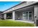 Covered back patio overlooking a well-maintained lawn, perfect for outdoor relaxation and entertaining at 2906 Boxwood Grove Row, Wesley Chapel, FL 33543