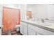 Bright bathroom featuring a double vanity with white cabinets and a shower with a peach-colored curtain at 2906 Boxwood Grove Row, Wesley Chapel, FL 33543