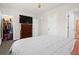 Cozy bedroom featuring a spacious closet, dresser with TV, and comfortable queen-size bed at 2906 Boxwood Grove Row, Wesley Chapel, FL 33543
