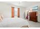 Cozy bedroom with white comforter, TV, and open closet space at 2906 Boxwood Grove Row, Wesley Chapel, FL 33543