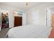 Bedroom featuring a dresser with a TV and an ensuite bathroom, and walk-in closet with open door at 2906 Boxwood Grove Row, Wesley Chapel, FL 33543