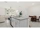 Open-concept kitchen with a large island, modern appliances, and seamless transition to the living area at 2906 Boxwood Grove Row, Wesley Chapel, FL 33543