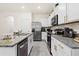 Well-equipped kitchen with granite countertops and stainless steel appliances is ready for meal preparation at 2906 Boxwood Grove Row, Wesley Chapel, FL 33543