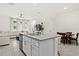 Kitchen island with granite countertops overlooks the living and dining areas at 2906 Boxwood Grove Row, Wesley Chapel, FL 33543