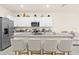 Gourmet kitchen featuring granite countertops, stainless steel appliances, and stylish island seating at 2906 Boxwood Grove Row, Wesley Chapel, FL 33543