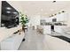 Open concept living space with kitchen island and stainless steel appliances at 2906 Boxwood Grove Row, Wesley Chapel, FL 33543
