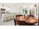 Bright, open-concept living space with island flows into the dining area and modern kitchen at 2906 Boxwood Grove Row, Wesley Chapel, FL 33543