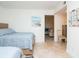 Cozy bedroom featuring two beds, neutral walls, and tile flooring leading to adjacent living space at 29147 Bay Hollow Dr # 3217, Wesley Chapel, FL 33543