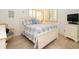 Cozy bedroom features a comfortable queen-size bed, plantation shutters, and relaxing decor at 29147 Bay Hollow Dr # 3217, Wesley Chapel, FL 33543