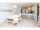 Bright dining area features a round table, seating for four, and opens to the modern kitchen at 29147 Bay Hollow Dr # 3217, Wesley Chapel, FL 33543