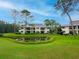 Exterior of a multi-Gathering property featuring mature trees and a pond at 29147 Bay Hollow Dr # 3217, Wesley Chapel, FL 33543