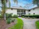 Beautiful two-story condo with a metal roof and lush landscaping surrounding the building at 29147 Bay Hollow Dr # 3217, Wesley Chapel, FL 33543