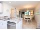 Open-concept kitchen with stainless steel appliances and seamless flow into the dining area at 29147 Bay Hollow Dr # 3217, Wesley Chapel, FL 33543