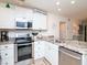 Kitchen area showcases granite countertops, modern appliances, and ample cabinet space at 29147 Bay Hollow Dr # 3217, Wesley Chapel, FL 33543