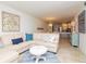 Comfortable living room features a plush sectional, coffee table, and opens to the dining and kitchen area at 29147 Bay Hollow Dr # 3217, Wesley Chapel, FL 33543
