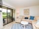 Bright living room features a plush sectional, coffee table, and sliding glass doors to outdoor view at 29147 Bay Hollow Dr # 3217, Wesley Chapel, FL 33543