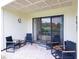 Cozy outdoor patio featuring comfortable chairs, a brick floor, and views of the golf course at 29147 Bay Hollow Dr # 3217, Wesley Chapel, FL 33543
