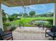 Relaxing patio with comfortable seating overlooking a well-manicured golf course and pond at 29147 Bay Hollow Dr # 3217, Wesley Chapel, FL 33543