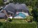 Aerial view showcasing a screened pool, manicured lawn, and mature landscaping at 2963 Cielo N Cir, Clearwater, FL 33759