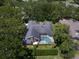 Aerial view of a well-maintained home with a large screened pool enclosure and lush landscaping at 2963 Cielo N Cir, Clearwater, FL 33759