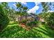 Lush backyard featuring a screened pool enclosure and well-maintained landscaping at 2963 Cielo N Cir, Clearwater, FL 33759